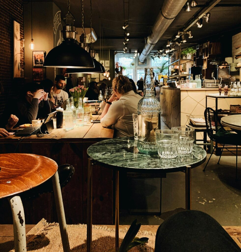 Warm and inviting modern restaurant interior with people dining and intriguing decor, perfect for lifestyle imagery.