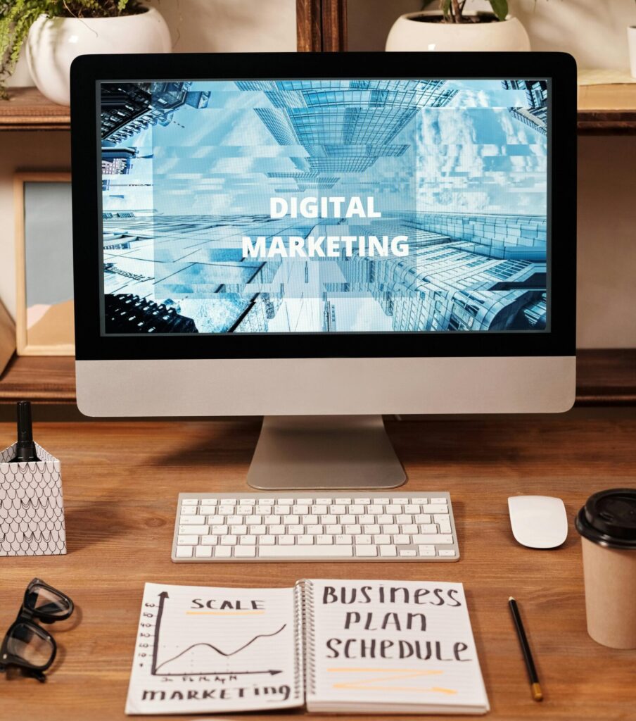 Contemporary office setup featuring digital marketing strategy on a computer screen, ideal for business technology themes.